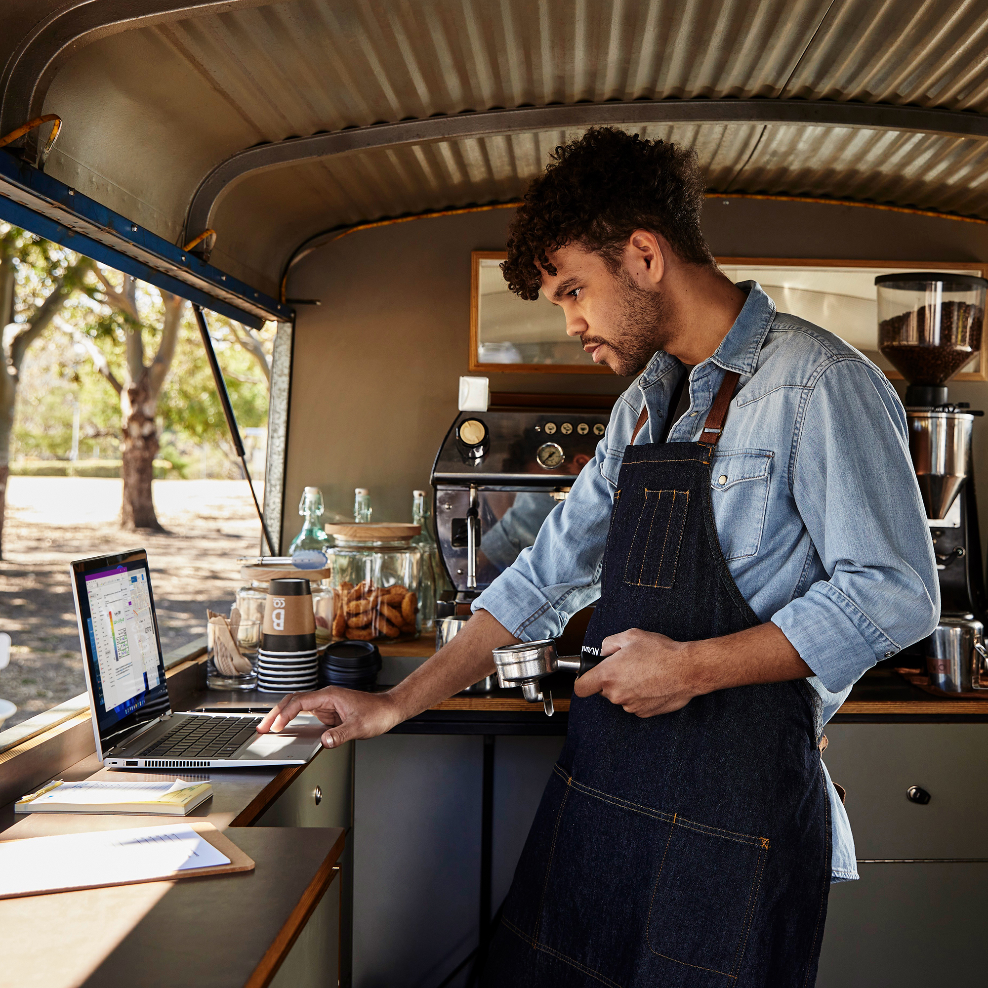 Man in a mobile store working on a laptop