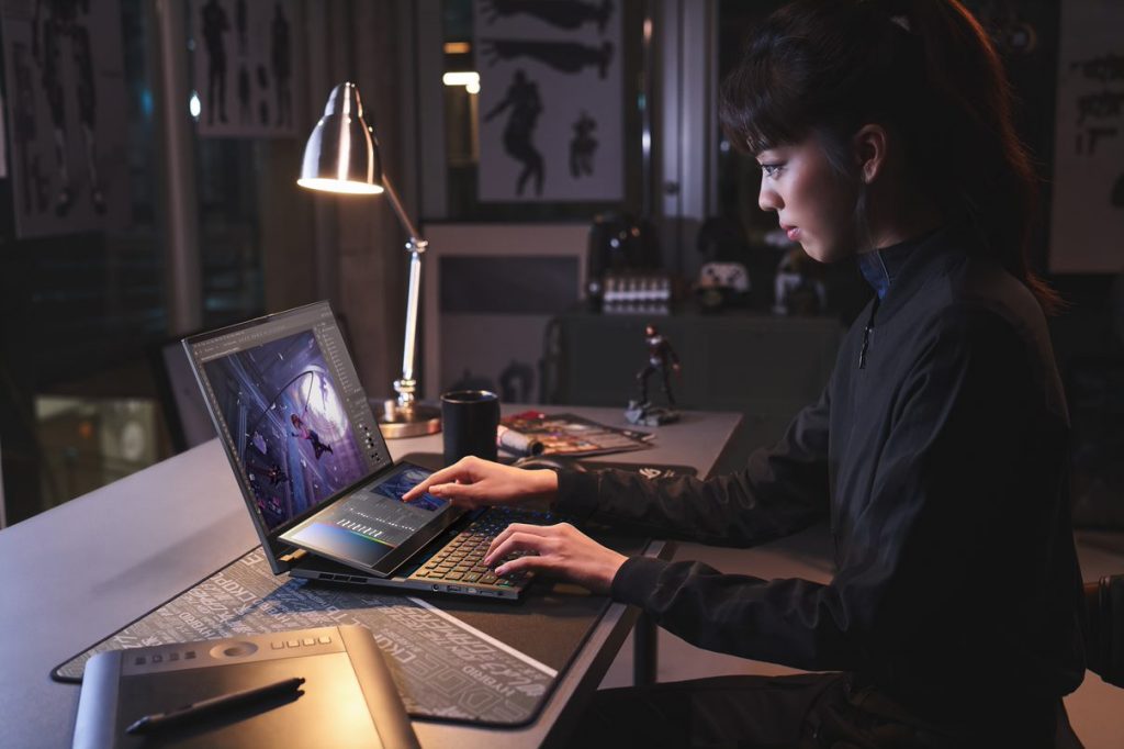 Woman sitting in front of ROG Zephyrus Duo 16 on a desk