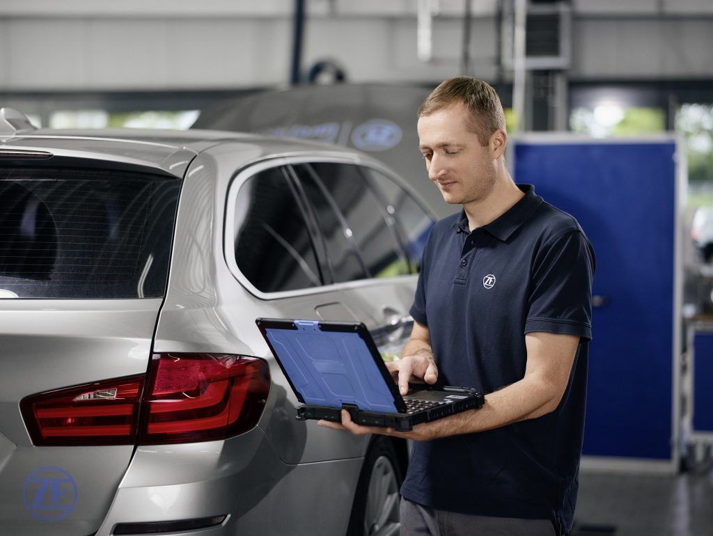 Auto worker next to vehicle