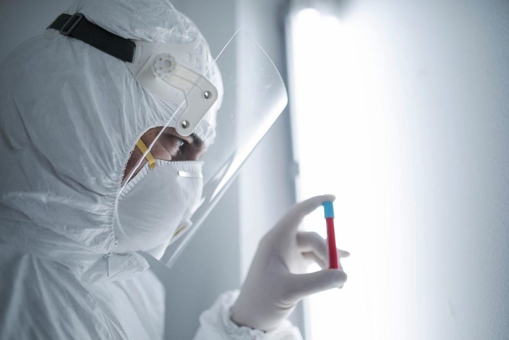 Lab technician with vial of blood