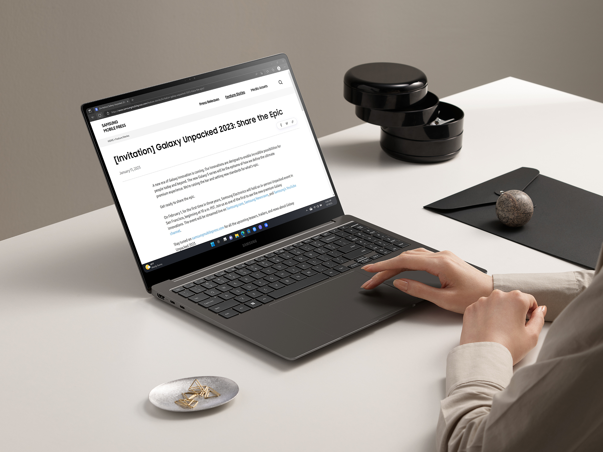 Woman sitting at a table working on Samsung laptop