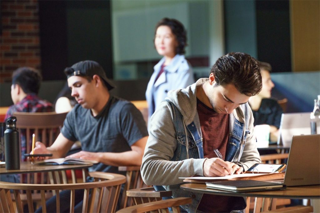 Students sitting at tables studying