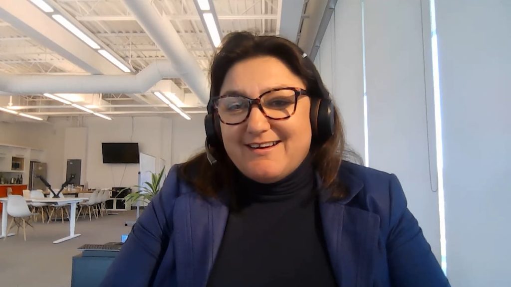 Women with glasses in an office looking at screen