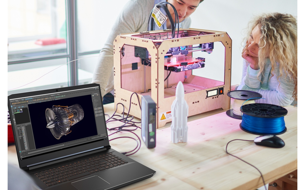 Two people looking at 3D maker device next to Acer laptop